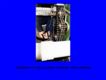 Slide 69: Employee trying to adjust machine when running